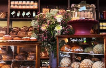 a bakery with many different types of breads and pastries